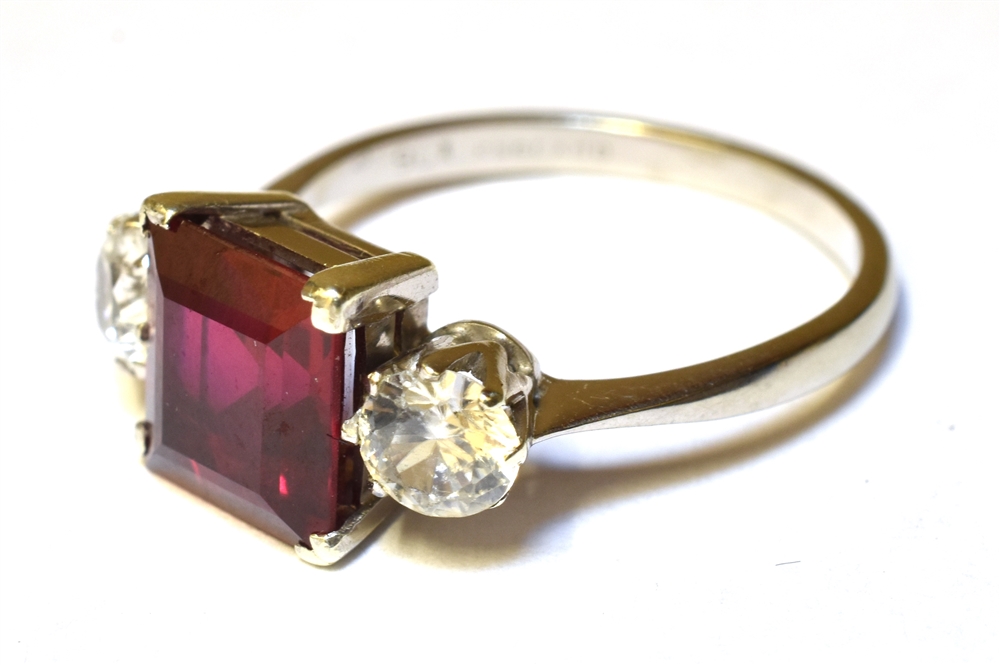 A SYNTHETIC RUBY AND SYNTHETIC WHITE SPINEL THREE STONE RING Claw settings to a 9ct white gold - Image 3 of 3