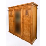 A GOOD VICTORIAN MAPLE AND CO TRIPLE WARDROBE with dentil moulded frieze, central mirror door