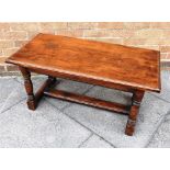 AN OAK OCCASIONAL TABLE the rectangular top with moulded edge, 46cm x 91cm, on block turned supports