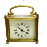 A BRASS CASED CARRIAGE CLOCK with French movement, the enamel with Roman numerals, 9.5cm wide 9cm