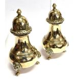 A PAIR OF SILVER PEPPERETTES Of baluster form on three lion mask feet, 10cm high, hallmarks for