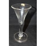 AN 18TH CENTURY WINE GLASS with trumpet shaped bowl and stem with elongated tear drop, on conical