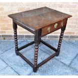 AN OAK SIDE TABLE the top with moulded edge, fitted with frieze drawer, on turned supports united by