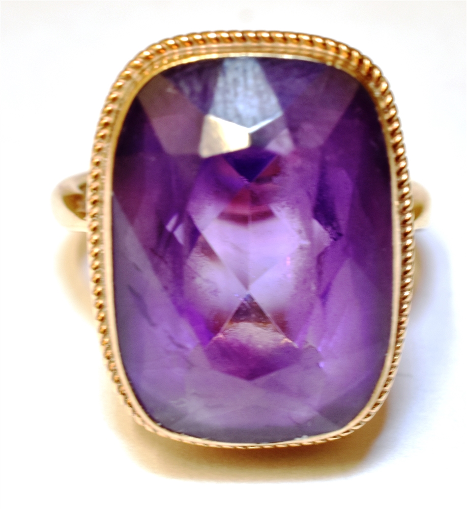 AN AMETHYST SINGLE STONE 9CT GOLD DRESS RING The cushion shaped amethyst 18mm x 13mm, ring size M,