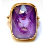 AN AMETHYST SINGLE STONE 9CT GOLD DRESS RING The cushion shaped amethyst 18mm x 13mm, ring size M,