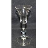 AN 18TH CENTURY WINE GLASS with bell shaped bowl, plain stem with baluster knop and tear drop