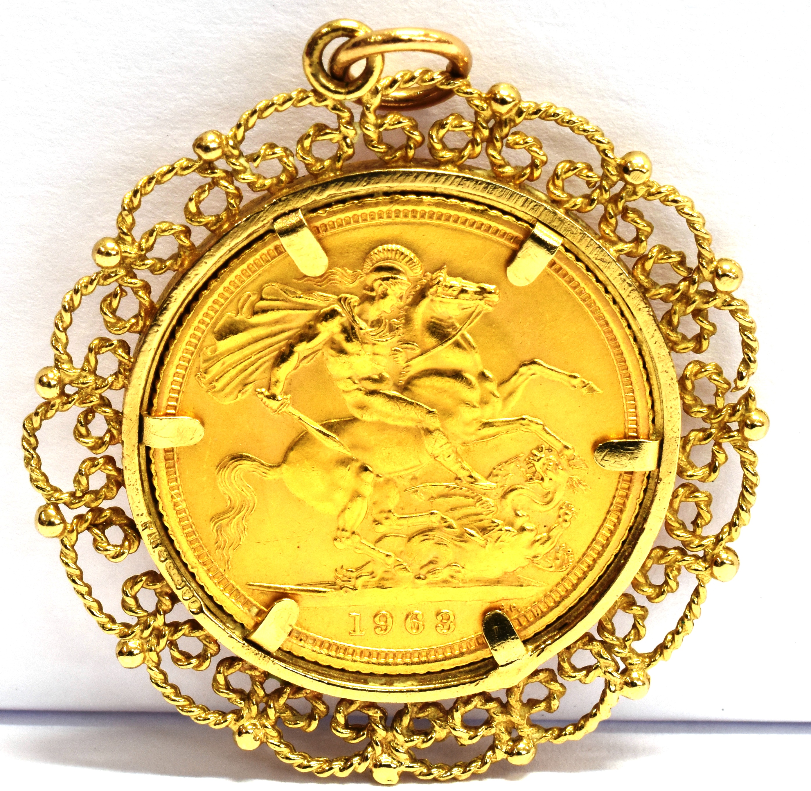 A FULL SOVEREIGN GOLD PENDANT The coin dated 1963 to a 9ct gold filigree pendant mount, gross weight - Image 2 of 2