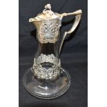 AN ART NOUVEAU DESIGN SILVER AND CLEAR GLASS CLARET JUG The silver top and central girdle with Art