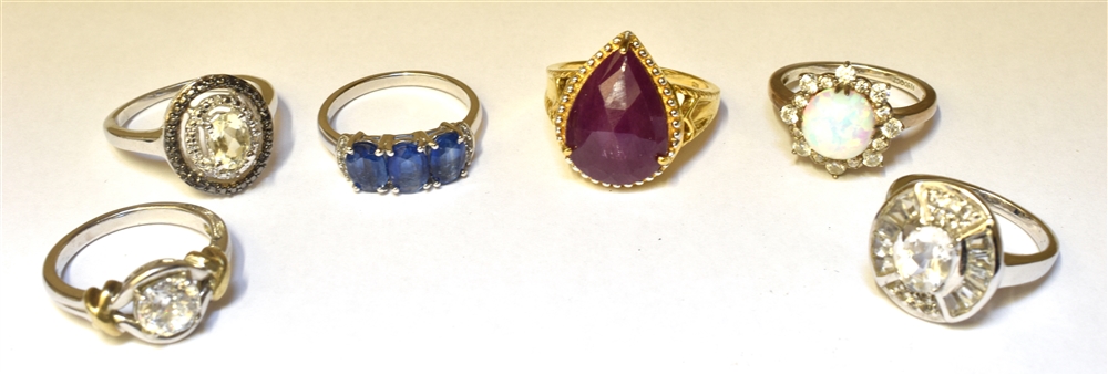 SIX SILVER STONE SET RINGS to include an opal cluster and a silver gilt single stone set with a