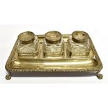 A GEORGIAN SILVER INKSTAND With three glass bottles, the four footed stand with pie-crust border