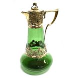 AN ART NOUVEAU DESIGN SILVER AND GREEN GLASS CLARET JUG The silver top and central girdle with Art