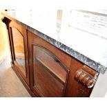 A VICTORIAN MARBLE TOP BOOKCASE with carved corbels, the glazed doors opening to two adjustable