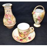 THREE ROYAL WORCESTER BLUSH IVORY ITEMS: a cup and saucer, date code for 1917; a vase with pierced