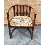 AN ARTS & CRAFTS STYLE OAK ARMCHAIR the bow back supported on shaped splats and pierced uprights