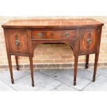 AN EDWARDIAN MAHOGANY BOWFRONT SIDEBOARD with central drawer flanked by cellarette and cupboard,