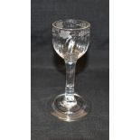 AN 18TH CENTURY WINE GLASS the bell shaped bowl engraved with vine leaves and grapes above rib