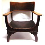 A MAHOGANY ARM CHAIR with curved backrail and dished seat