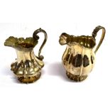 TWO SILVER MILK JUGS Both of helmet shape with fluted decoration and acanthus decorated handle and