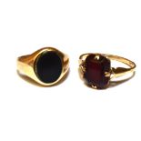 TWO 9CT GOLD STONE SET RINGS Comprising a black onyx set small signet ring, size G; and a garnet set
