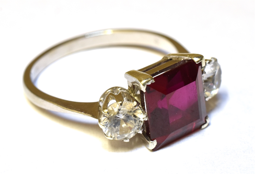 A SYNTHETIC RUBY AND SYNTHETIC WHITE SPINEL THREE STONE RING Claw settings to a 9ct white gold - Image 2 of 3