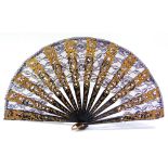 A BLACK MACHINE LACE FAN the fret-cut guards and sticks with gilt painted fruit, leaf and scrollwork