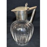 A SILVER TOPPED GLASS CLARET JUG The silver mounts of plain form with flat lid and angular handle,