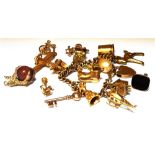 A 9CT GOLD CHARM BRACELET With padlock fastener and eleven assorted charms; together with six