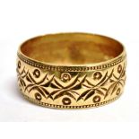A 9CT GOLD PATTERNED WEDDING BAND With millegrain edge decoration, 8mm wide, ring size O, weighing