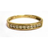 A DIAMOND TEN STONE HALF ETRNITY 9CT GOLD RING Channel set with a total diamond weight approx. 0.