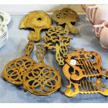 FIVE PAIRS OF VICTORIAN BRASS TRIVETS