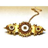 A VICTORIAN ETRUSCAN STYLE 15CT GOLD BROOCH The three section target bar brooch set with a small