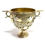 A VICTORIAN SILVER PUNCH BOWL The goblet form bowl on pedestal base with repousse leaf, berry and