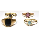 FOUR 9CT GOLD RINGS Comprising two stone set dress rings; to include an amethyst set and a blue