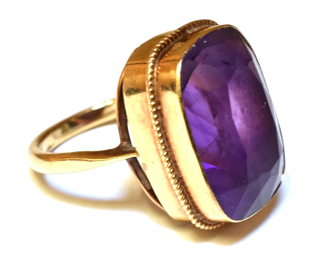 AN AMETHYST SINGLE STONE 9CT GOLD DRESS RING The cushion shaped amethyst 18mm x 13mm, ring size M, - Image 2 of 2