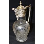 A VICTORIAN SILVER TOPPED GLASS CLARET JUG The masked head silver top with embossed decoration and