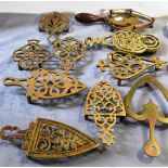 A GROUP OF TEN VICTORIAN BRASS TRIVETS