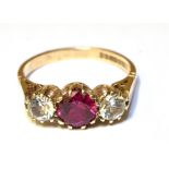 A SYNTHETIC RUBY AND SYNTHETIC WHITE SPINEL ZIRCONIA THREE STONE RING Claw set to a 9ct yellow