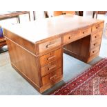 A LARGE 1930S WALNUT TWIN PEDESTAL DESK with three frieze drawers (one drawer front detached but