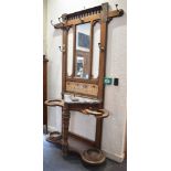 A VICTORIAN OAK AESTHETIC MOVEMENT HALLSTAND the mirrored back inset with four Minton tiles