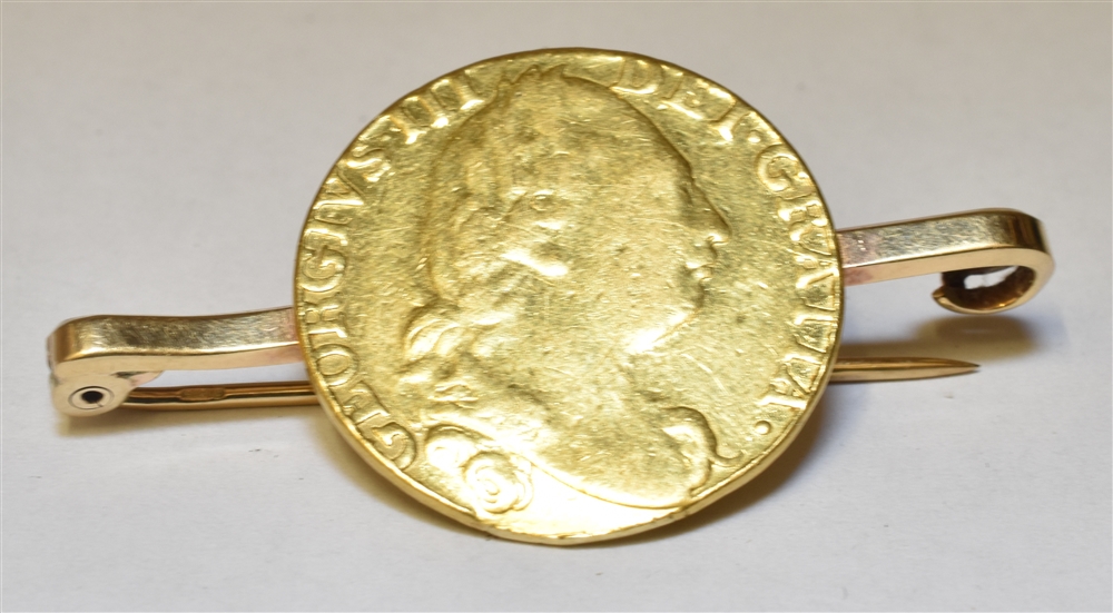 A ONE GUINEA GOLD COIN BAR BROOCH The coin dated 1784 soldered to a 9ct gold bar brooch,
