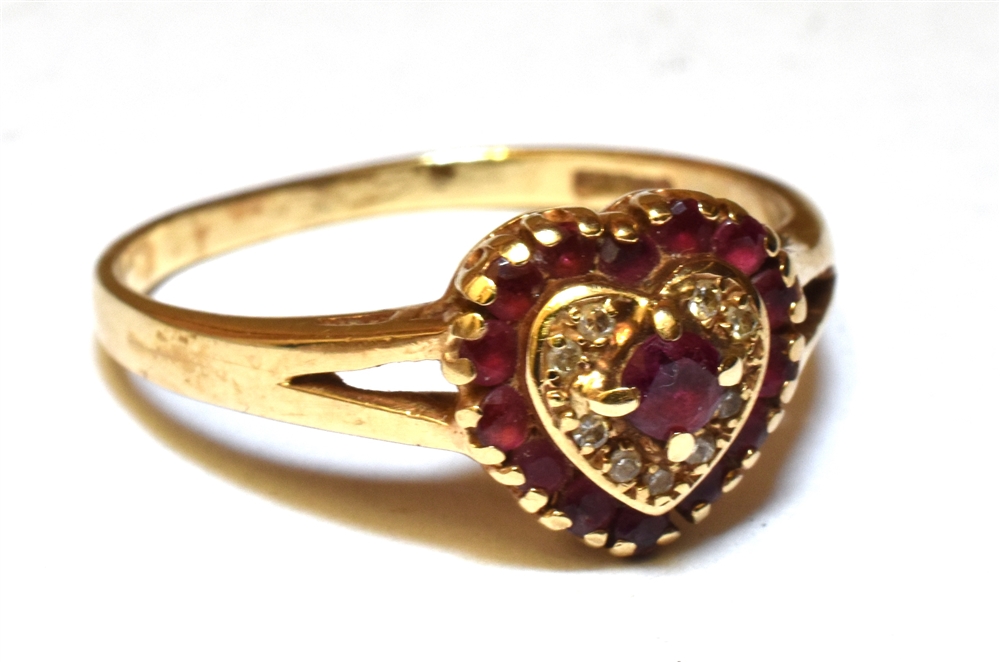 A RUBY AND DIAMOND HEART SHAPED CLUSTER RING Yellow gold claw settings, split shoulders to a