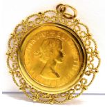 A FULL SOVEREIGN GOLD PENDANT The coin dated 1963 to a 9ct gold filigree pendant mount, gross weight