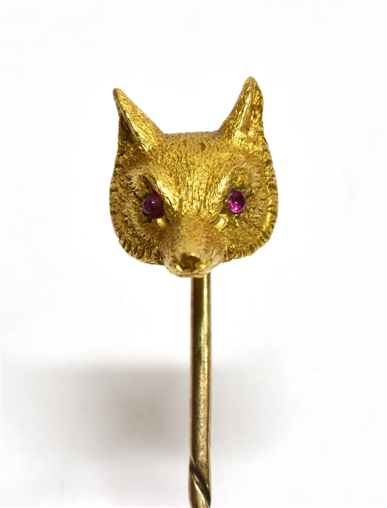 A YELLOW GOLD FOX HEAD STICKPIN Set with ruby eyes, unmarked, the head assessed as 9ct gold, gross