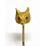 A YELLOW GOLD FOX HEAD STICKPIN Set with ruby eyes, unmarked, the head assessed as 9ct gold, gross