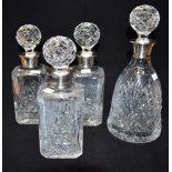 A SET OF THREE MODERN SILVER RIMMED CUT GLASS SQUARE DECANTERS with cut glass bulbous stoppers,