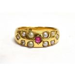 A VICTORIAN RUBY AND SEED PEARL SET 18CT GOLD BAND RING Small ruby to centre with half round seed