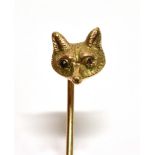 A YELLOW GOLD FOX HEAD STICKPIN Set with ruby eyes, unmarked the head assessed as 9ct gold, gross
