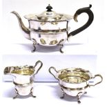 A MAPPIN AND WEBB THREE PIECE SILVER TEASET The cauldron shaped teaset on four paw feet,