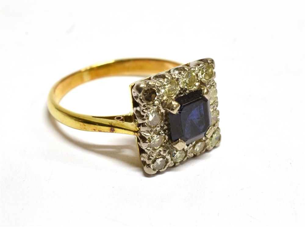 A SAPPHIRE AND DIAMOND SQUARE CLUSTER 18 CT GOLD RING the central square cut dark blue sapphire