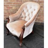 A VICTORIAN CARVED MAHOGANY FRAMED BUTTON UPHOLSTERED ARMCHAIR on cabriole supports